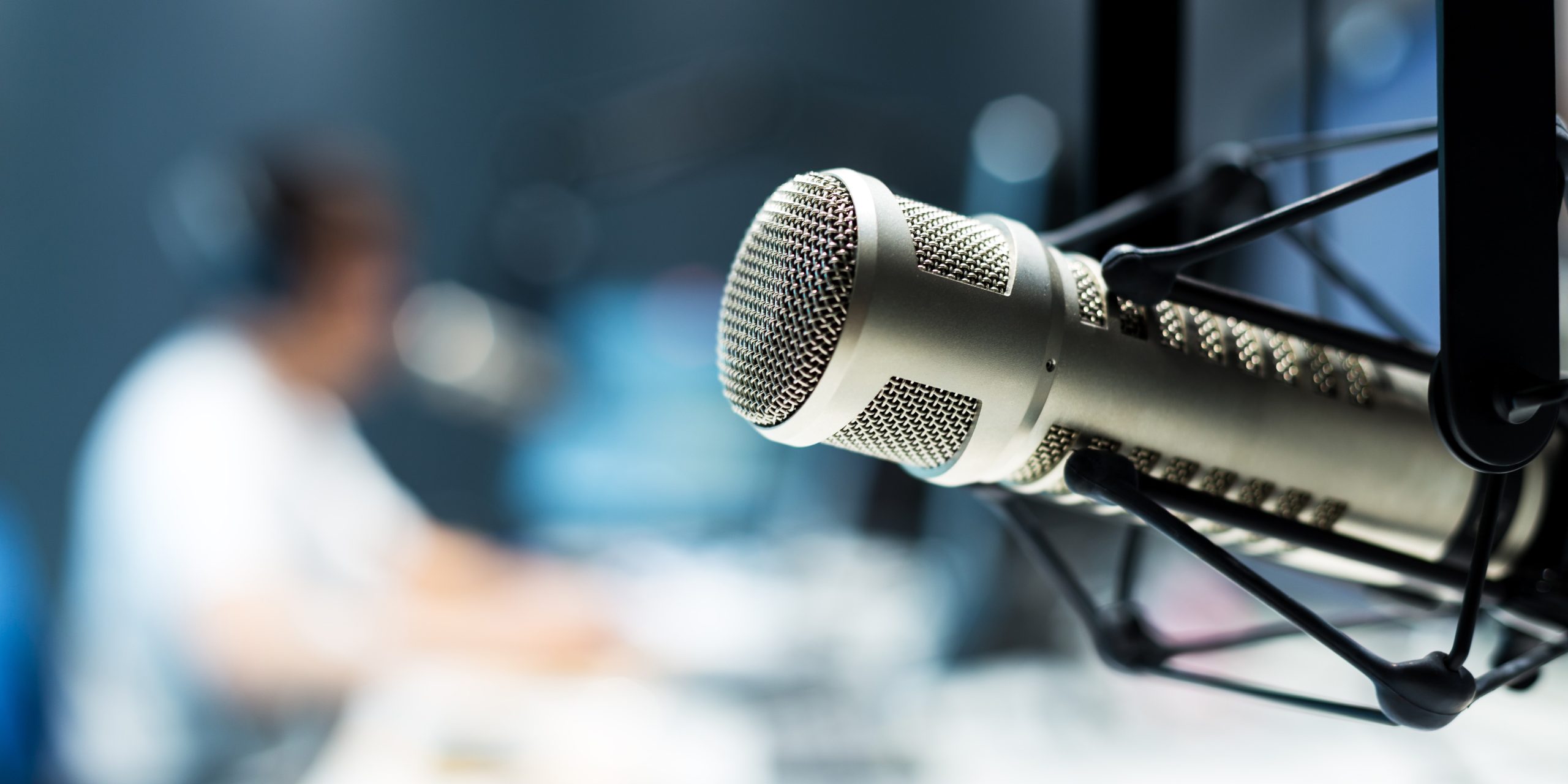 young man dj works in modern broadcast studio
